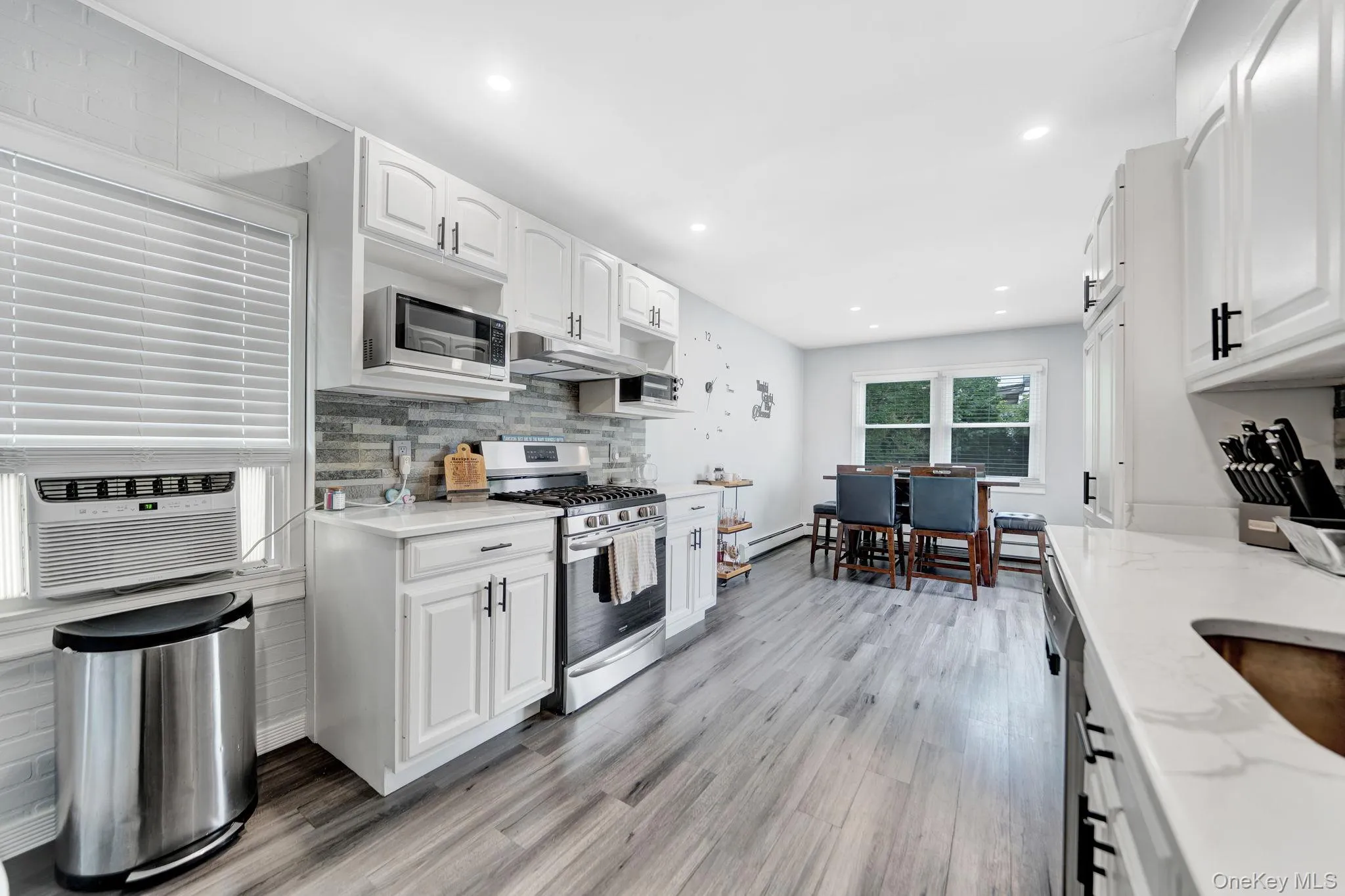 Kitchen featuring vinyl planks, recessed lighting, quartz countertops and gas stove Kitchen featuring vinyl planks, recessed lighting, quartz countertops and gas stove