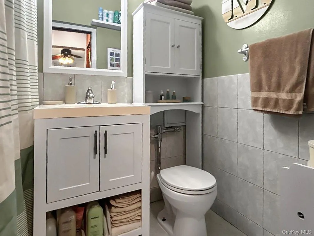 White vanity with integrated sink, chrome faucet, and closed cabinetry White vanity with integrated sink, chrome faucet, and closed cabinetry