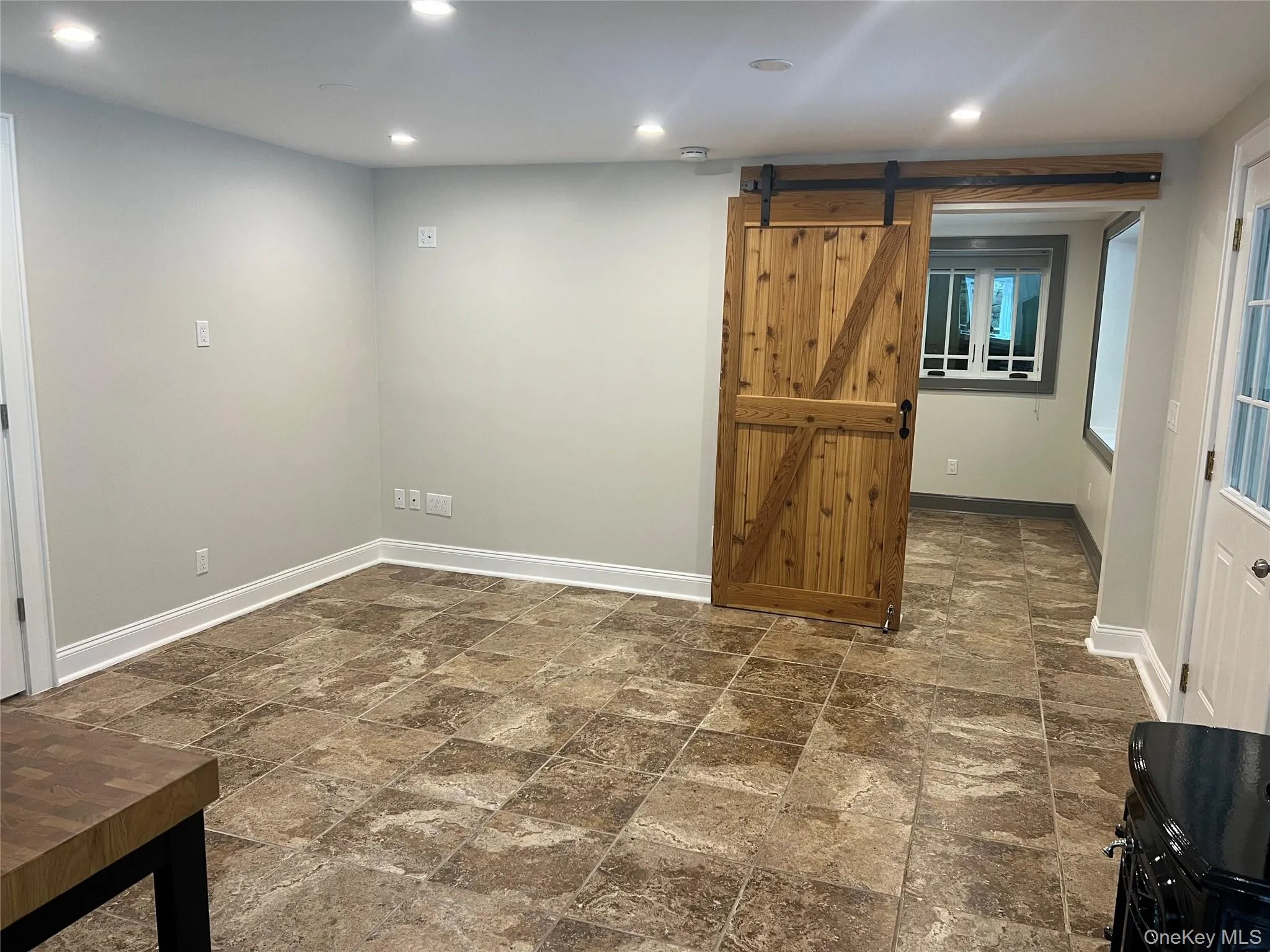 Living area with barn door leading to bedroom Living area with barn door leading to bedroom