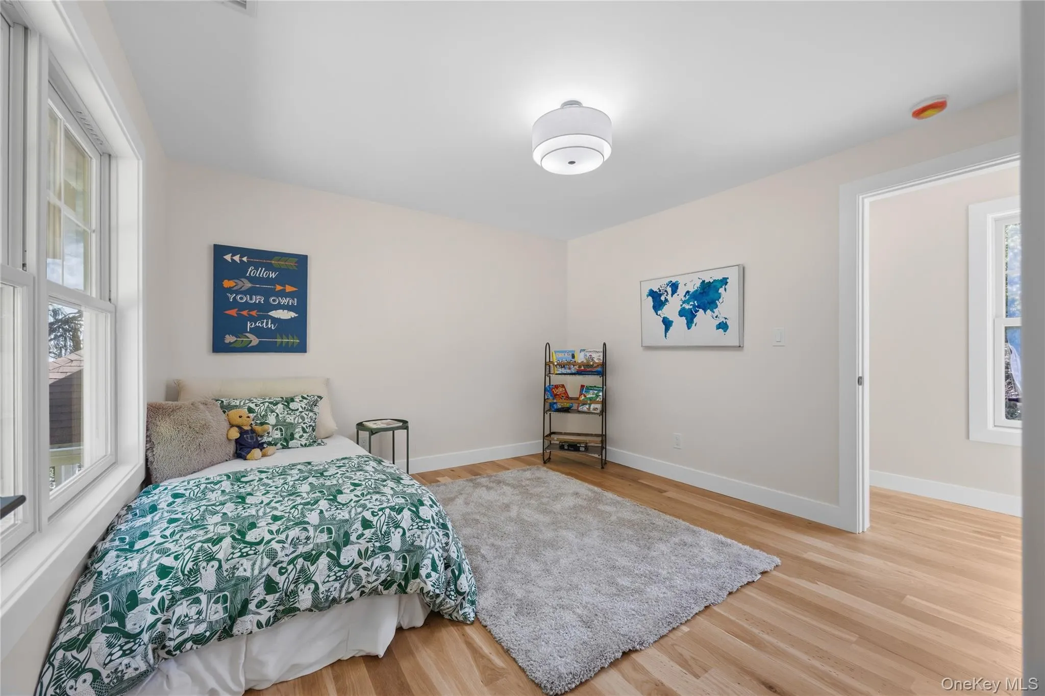 Hardwood flooring, painted walls, white trim, and a ceiling-mounted light fixture Hardwood flooring, painted walls, white trim, and a ceiling-mounted light fixture