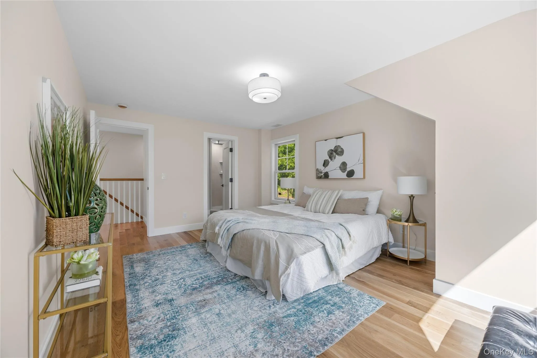 Light wood-finish flooring, recessed lighting, white trim, and a window with exterior views Light wood-finish flooring, recessed lighting, white trim, and a window with exterior views