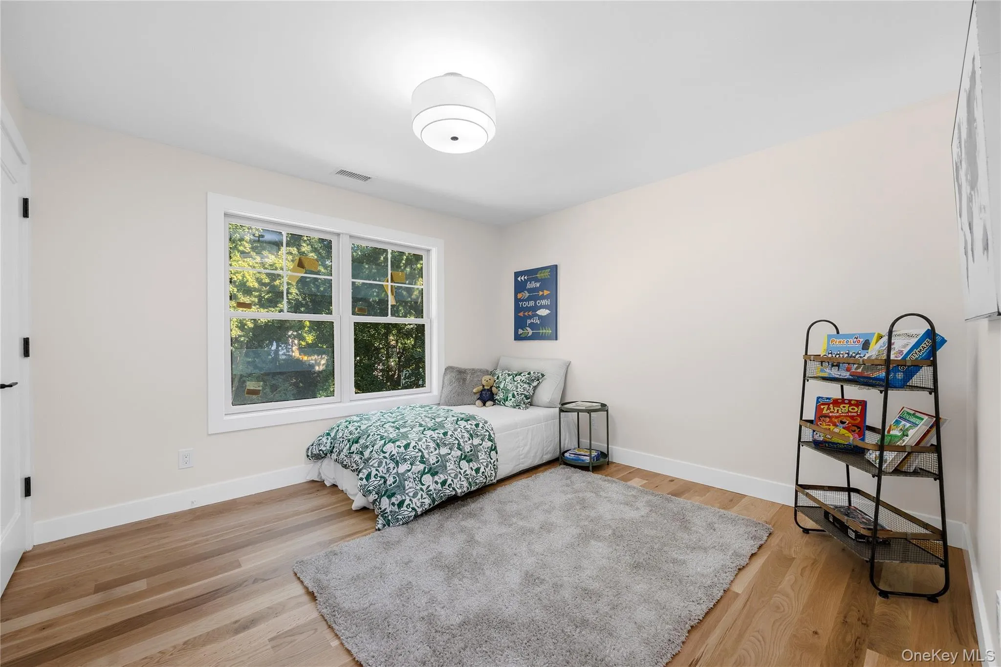Hardwood flooring, recessed lighting, white trim, and a large window Hardwood flooring, recessed lighting, white trim, and a large window