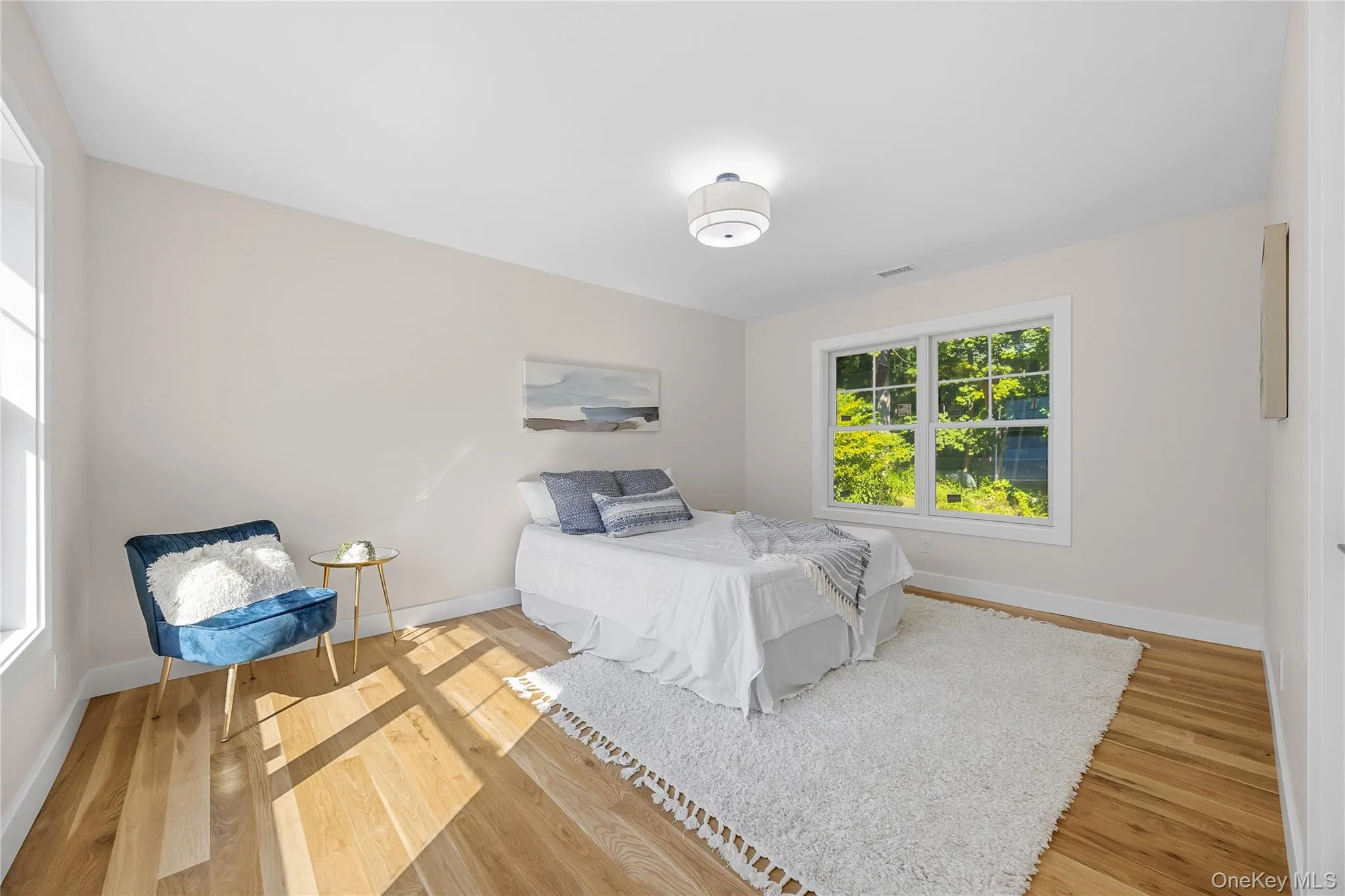 Hardwood-finish flooring, white trim, recessed lighting, and ample natural light from two windows Hardwood-finish flooring, white trim, recessed lighting, and ample natural light from two windows