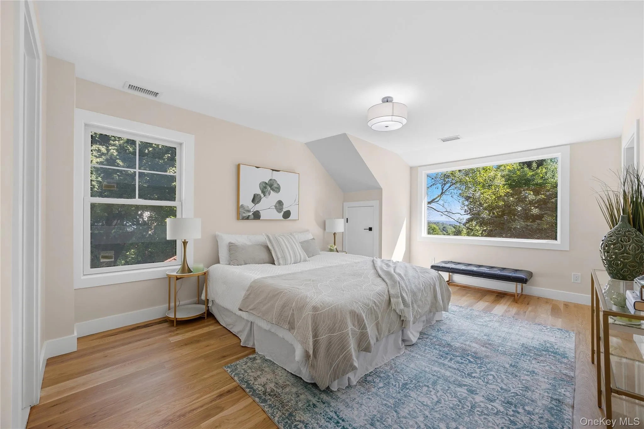 Hardwood flooring, multiple windows, recessed lighting, and a contemporary ceiling light fixture Hardwood flooring, multiple windows, recessed lighting, and a contemporary ceiling light fixture