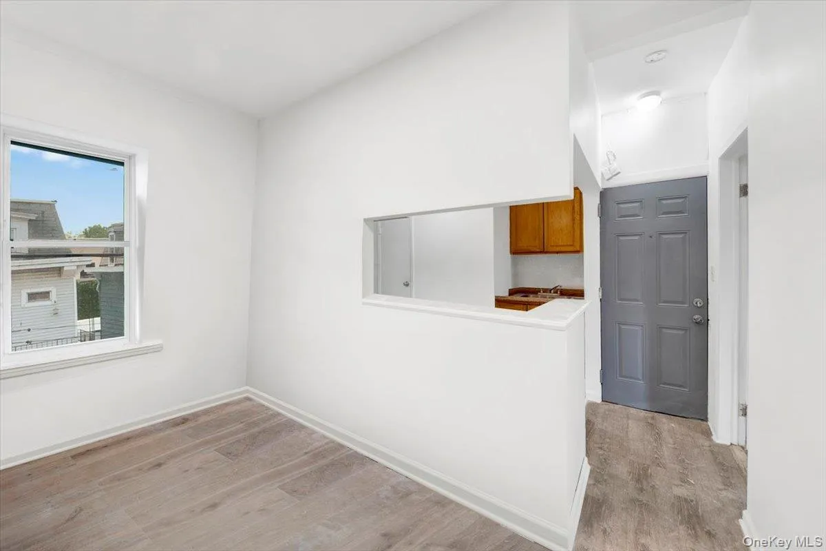 Spare room featuring light wood-type flooring and baseboards Spare room featuring light wood-type flooring and baseboards