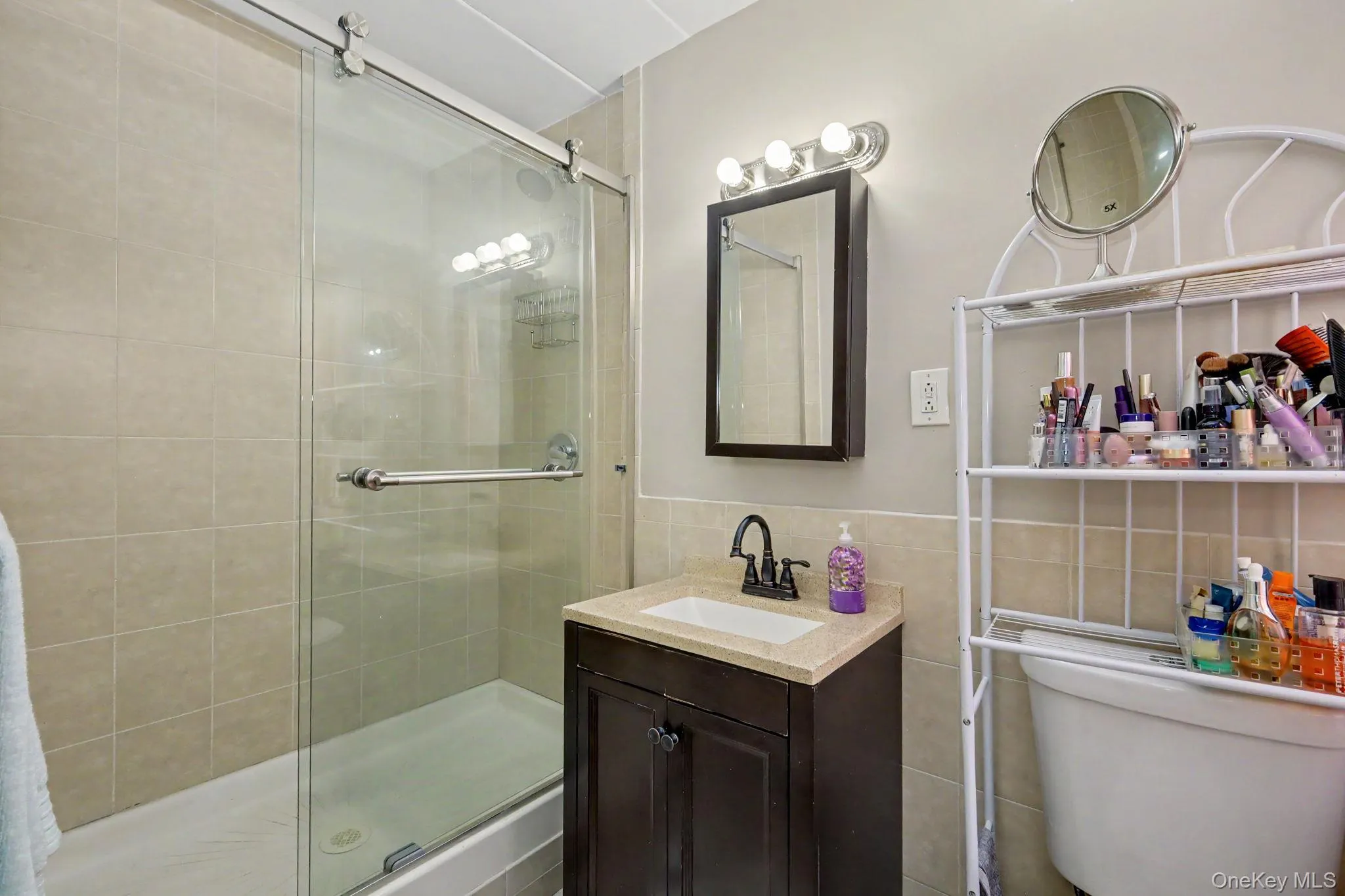 Glass-enclosed shower with tile surround Glass-enclosed shower with tile surround