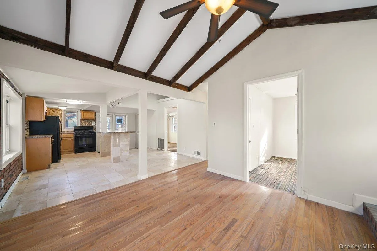 Unfurnished living room with light wood-style floors and ceiling fan Unfurnished living room with light wood-style floors and ceiling fan