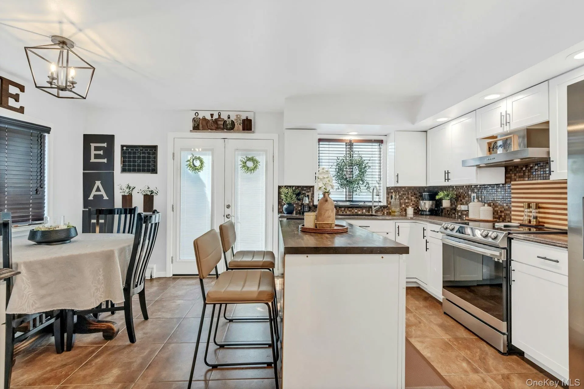Kitchen view with dining area, island, recessed lighting and stainless steel appliances Kitchen view with dining area, island, recessed lighting and stainless steel appliances