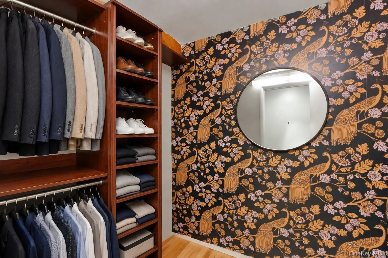 Custom built-in closet system with multiple shelving units and hanging rods Custom built-in closet system with multiple shelving units and hanging rods