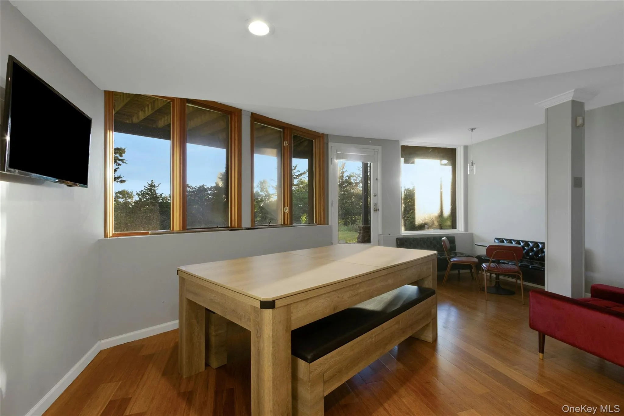Wood-finish flooring throughout, complemented by a recessed light and multiple windows Wood-finish flooring throughout, complemented by a recessed light and multiple windows