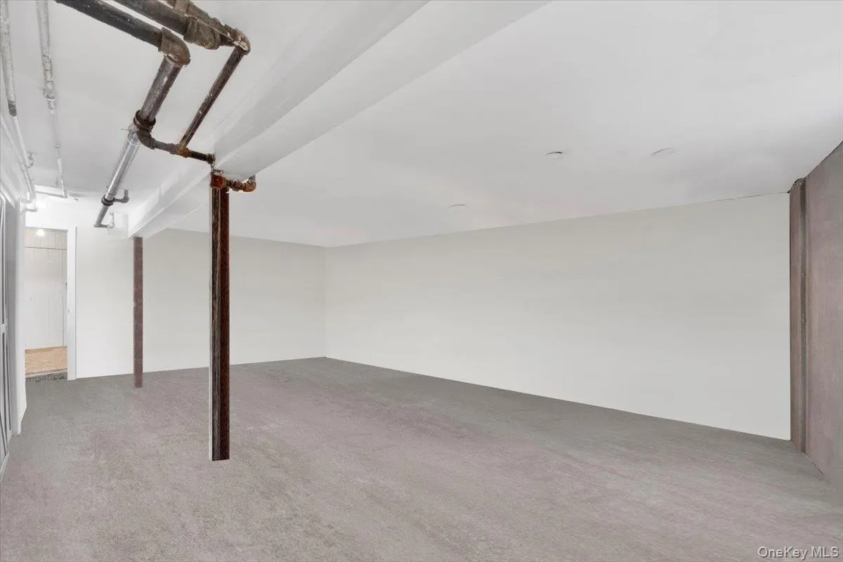 Finished below grade area featuring carpet floors Finished below grade area featuring carpet floors