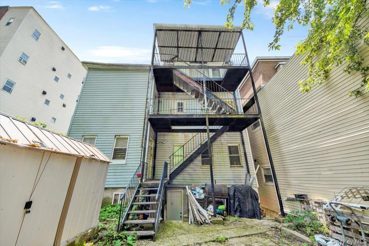Rear view of property featuring stairs Rear view of property featuring stairs