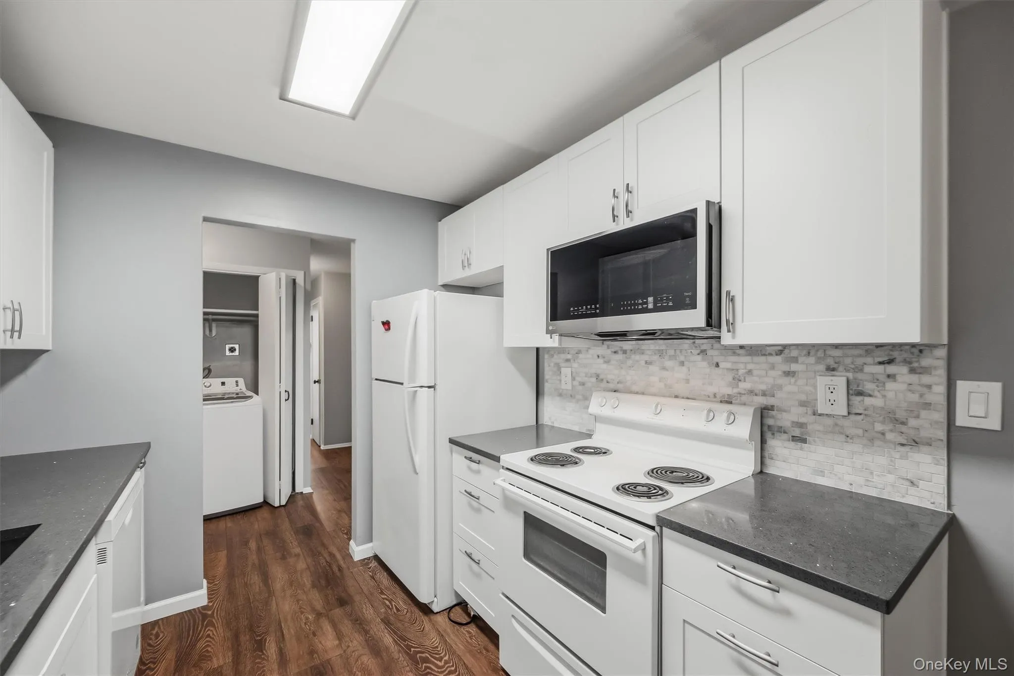 Updated kitchen featuring white cabinetry, coordinated finishes, and included appliances. Updated kitchen featuring white cabinetry, coordinated finishes, and included appliances.