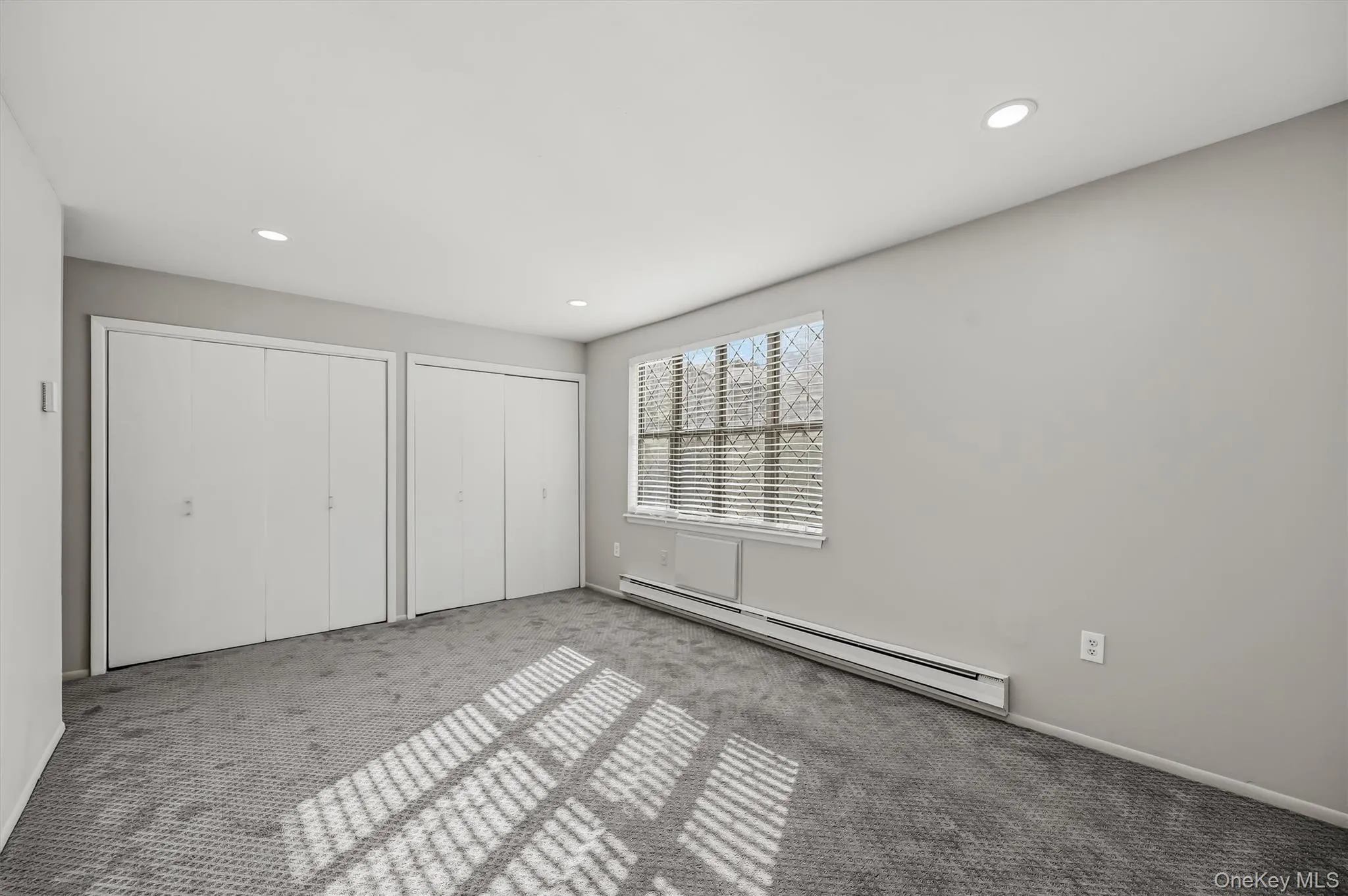 Additional primary bedroom view highlighting the generous closet space. Additional primary bedroom view highlighting the generous closet space.