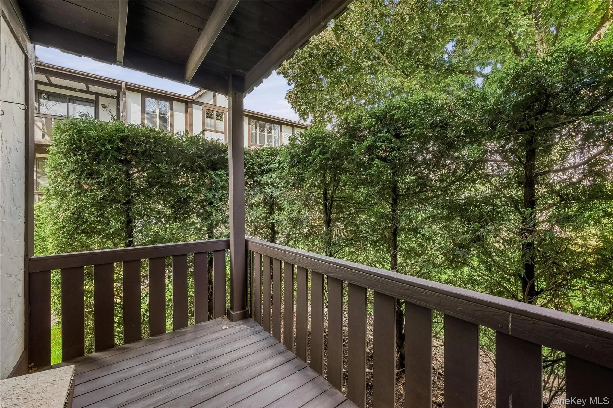 Private covered balcony surrounded by mature greenery. Private covered balcony surrounded by mature greenery.