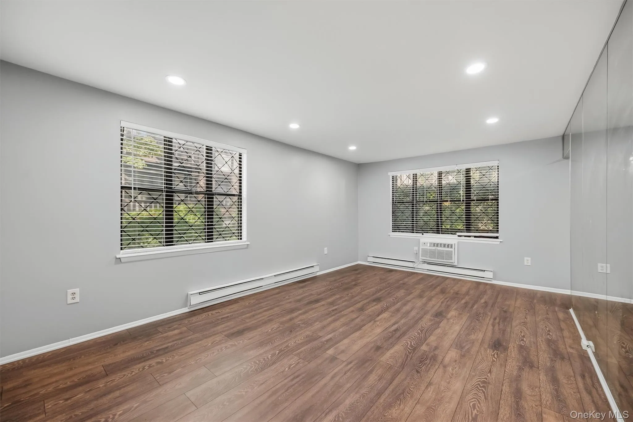 Large living room with multiple windows providing abundant natural light. Large living room with multiple windows providing abundant natural light.