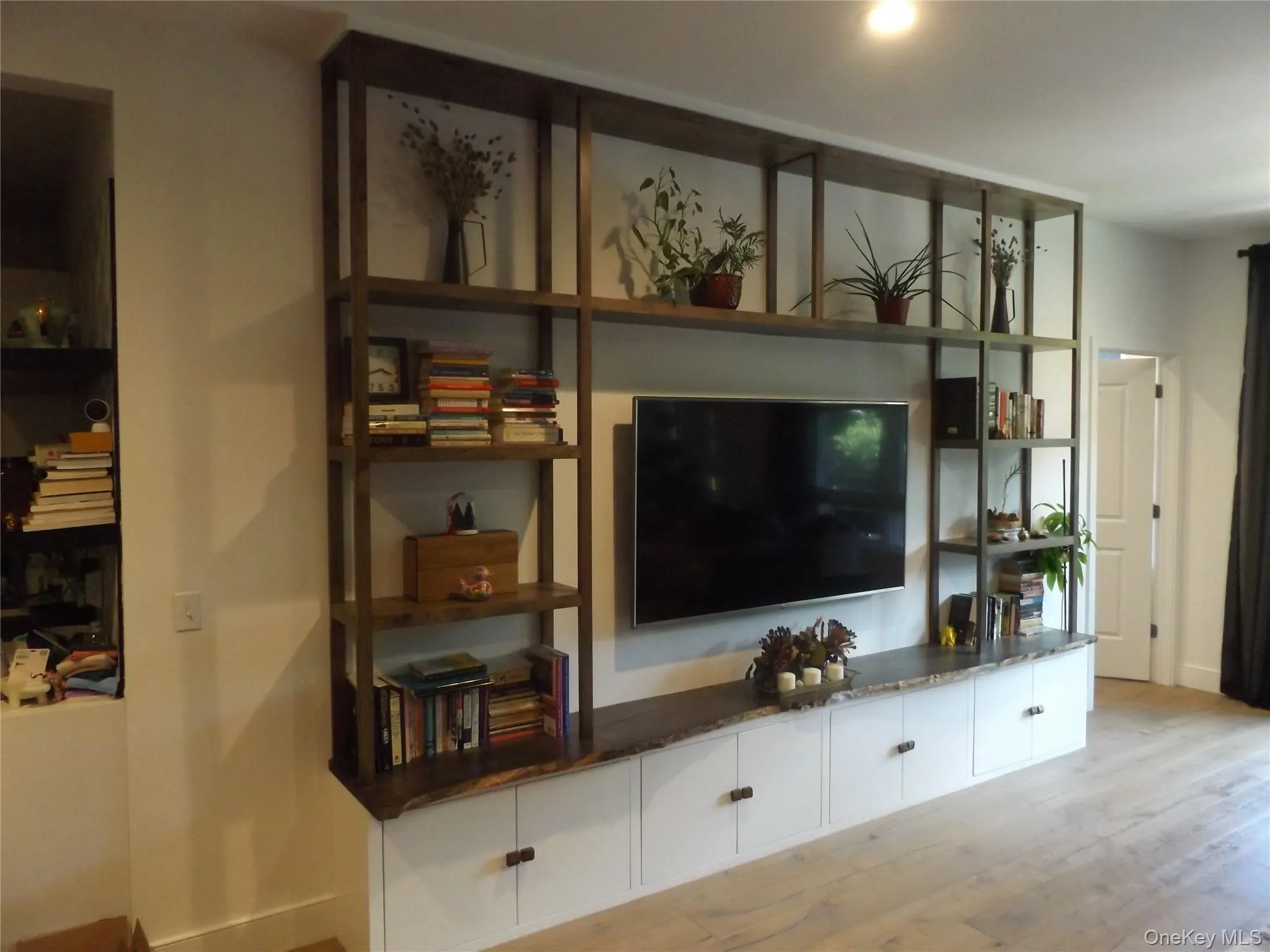 Living area with light wood finished floors and baseboards Living area with light wood finished floors and baseboards