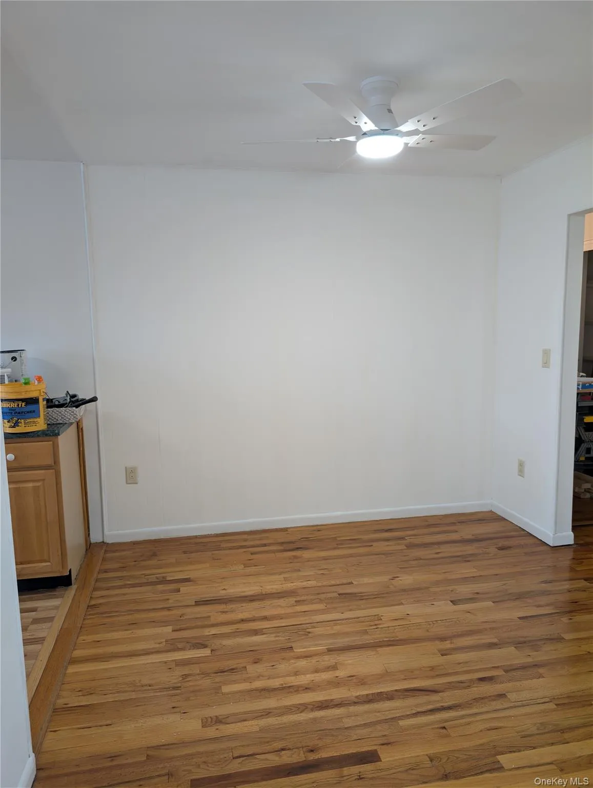 Hardwood floors, ceiling fan/light fixture opens to kitchen and living room Hardwood floors, ceiling fan/light fixture opens to kitchen and living room