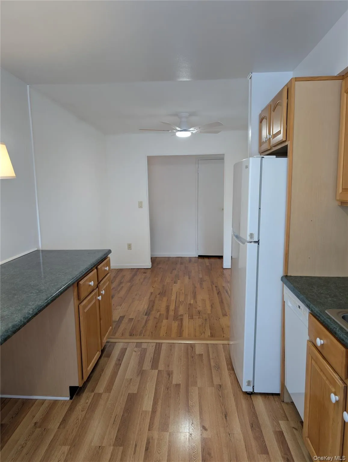 Kitchen with wood-finish flooring, light maple wood cabinetry (with pull outs), laminate countertops and breakfast area Kitchen with wood-finish flooring, light maple wood cabinetry (with pull outs), laminate countertops and breakfast area
