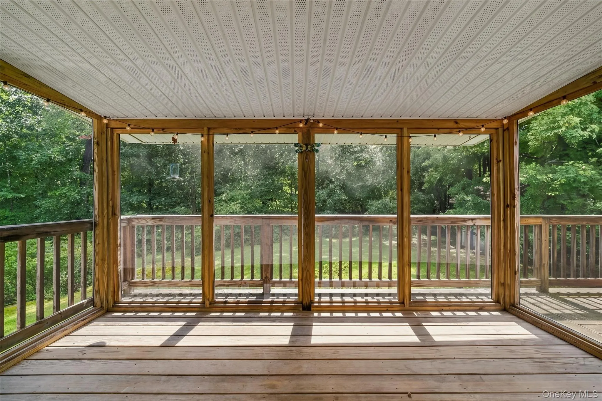 Screened porch featuring wood-finish decking, Screened porch featuring wood-finish decking,