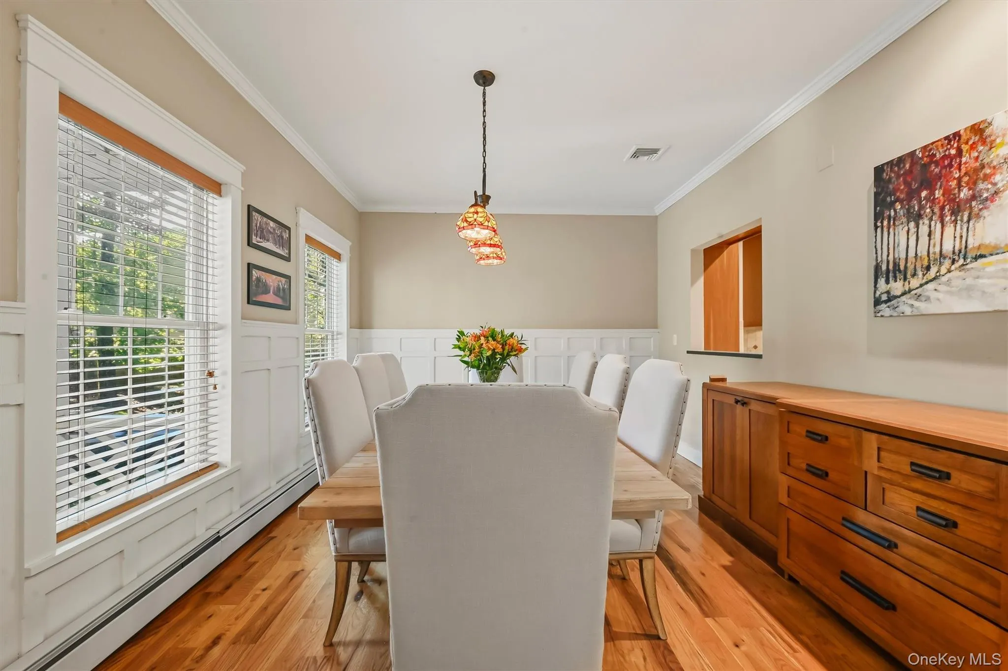Beautifully appointed dining room with picture-frame molding and a statement sideboard providing ample buffet storage. Beautifully appointed dining room with picture-frame molding and a statement sideboard providing ample buffet storage.