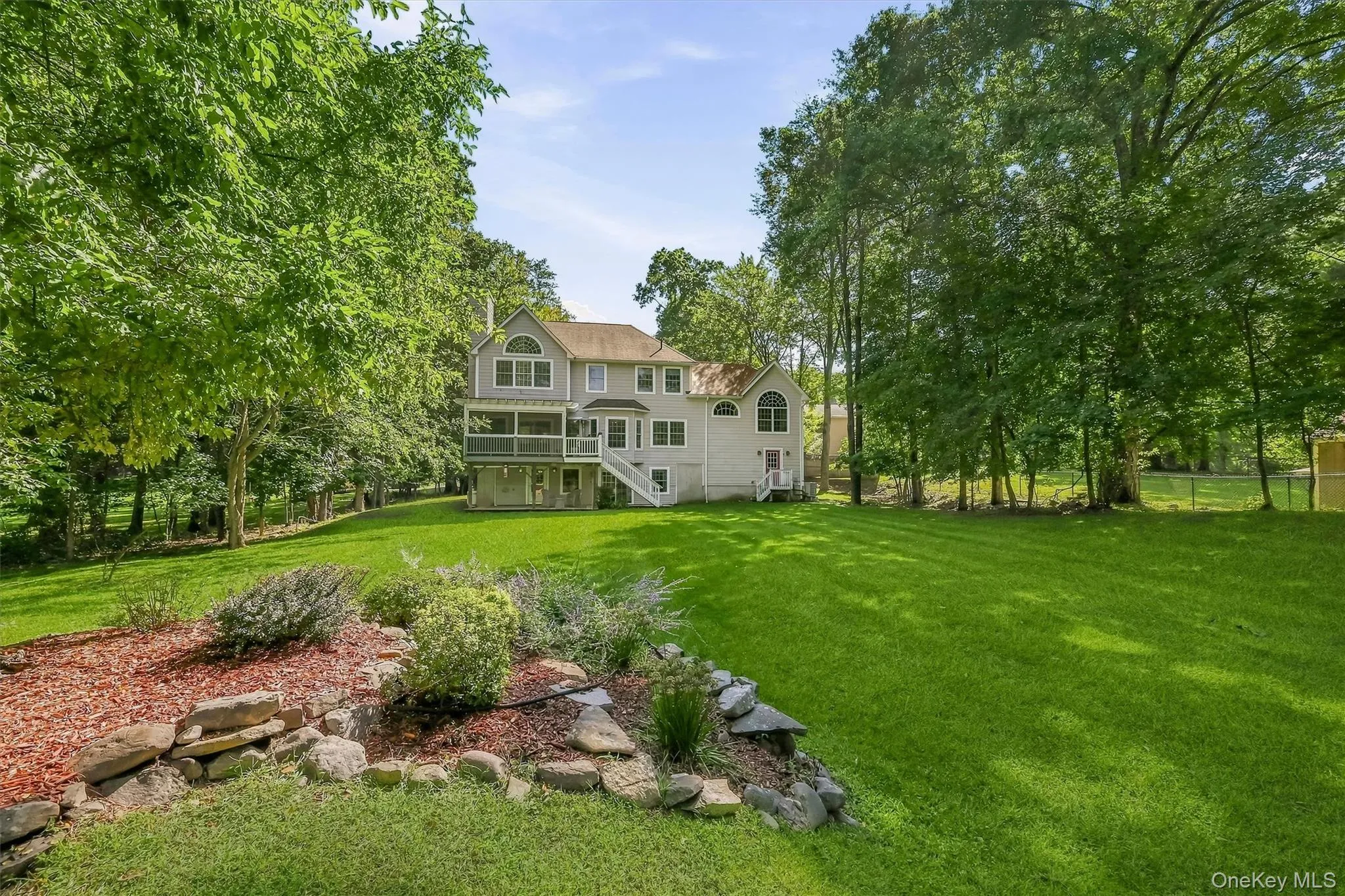 Spacious backyard unfolds through mature landscaping toward the lakefront, with plenty of room to play and enjoy the outdoors. Spacious backyard unfolds through mature landscaping toward the lakefront, with plenty of room to play and enjoy the outdoors.