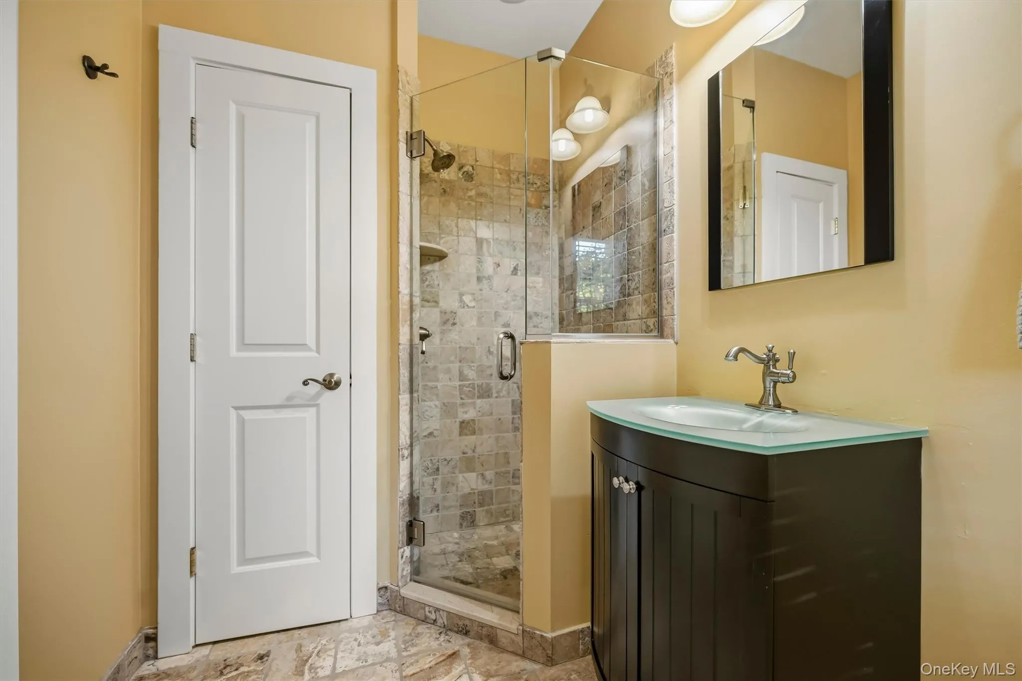 Well-appointed full bath just steps from the game room. Well-appointed full bath just steps from the game room.