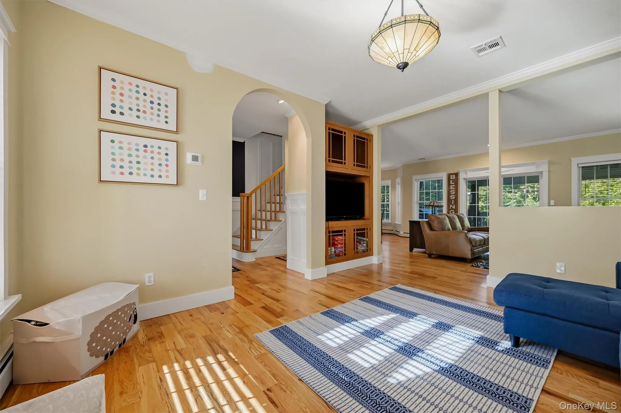 The main living room with classic detailing and natural wood finishes includes a built-in media cabinet. The main living room with classic detailing and natural wood finishes includes a built-in media cabinet.