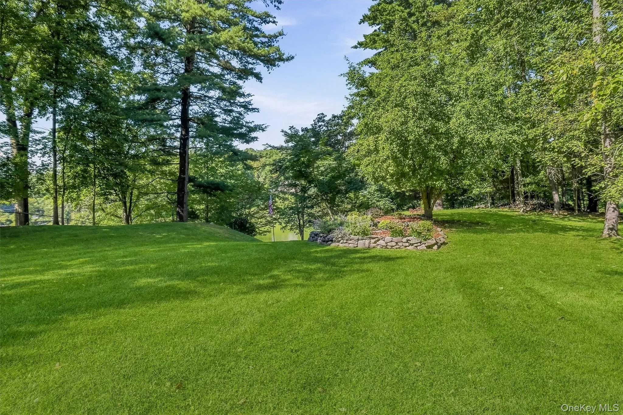 Beautifully landscaped grounds gently slope toward the water, creating a private lakeside retreat. Beautifully landscaped grounds gently slope toward the water, creating a private lakeside retreat.