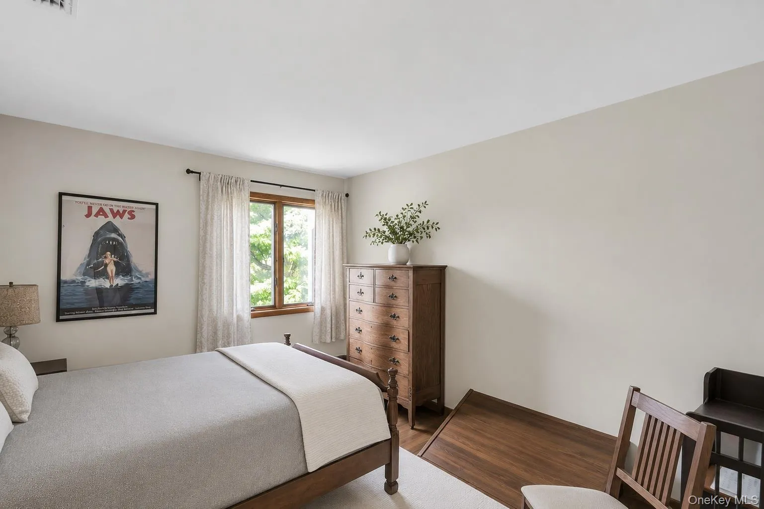 Bedroom 2. Wood-frame window, light-toned walls, and wood-finish flooring Bedroom 2. Wood-frame window, light-toned walls, and wood-finish flooring