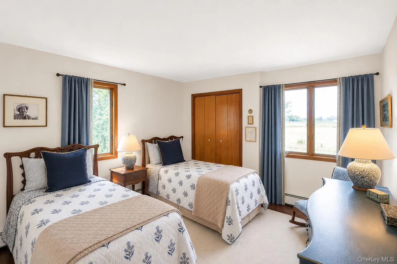 Bedroom 3. Hardwood window frames, neutral wall paint, wood-finish closet doors, and light-toned carpeting Bedroom 3. Hardwood window frames, neutral wall paint, wood-finish closet doors, and light-toned carpeting