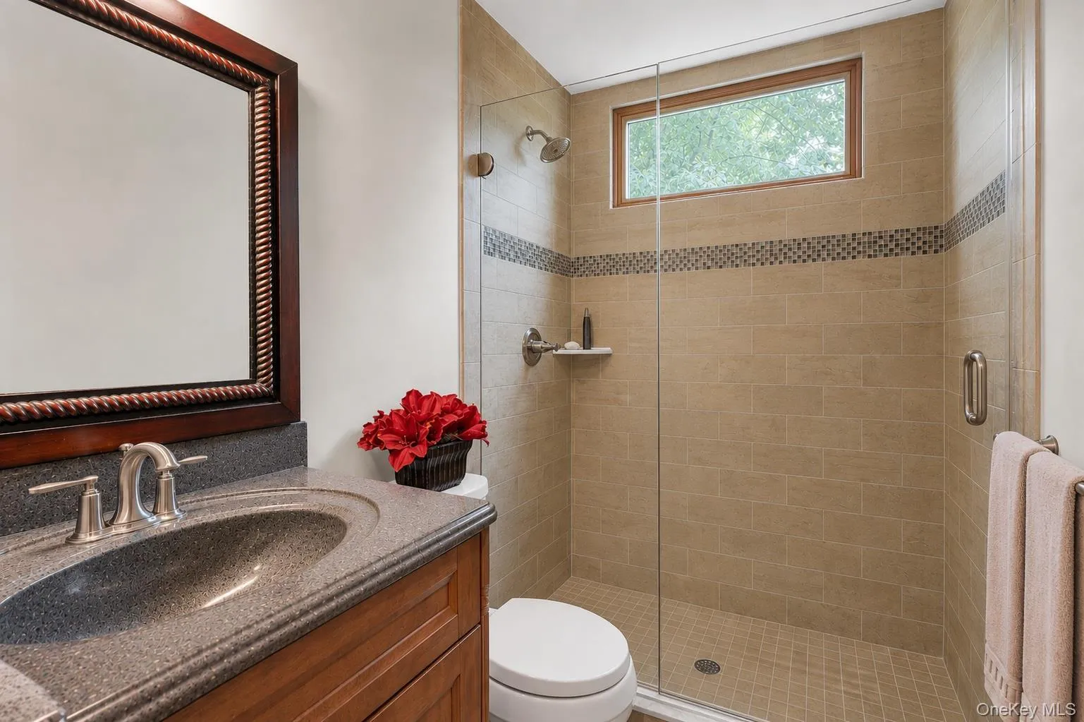 First Floor Full Bathroom. Wood-finish vanity with an integrated sink and brushed nickel faucet First Floor Full Bathroom. Wood-finish vanity with an integrated sink and brushed nickel faucet