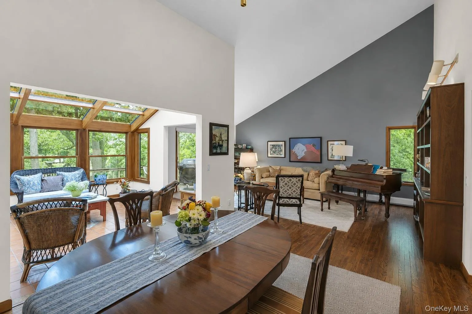 Dining area with wood-finish flooring open to sun room and the living room areas Dining area with wood-finish flooring open to sun room and the living room areas