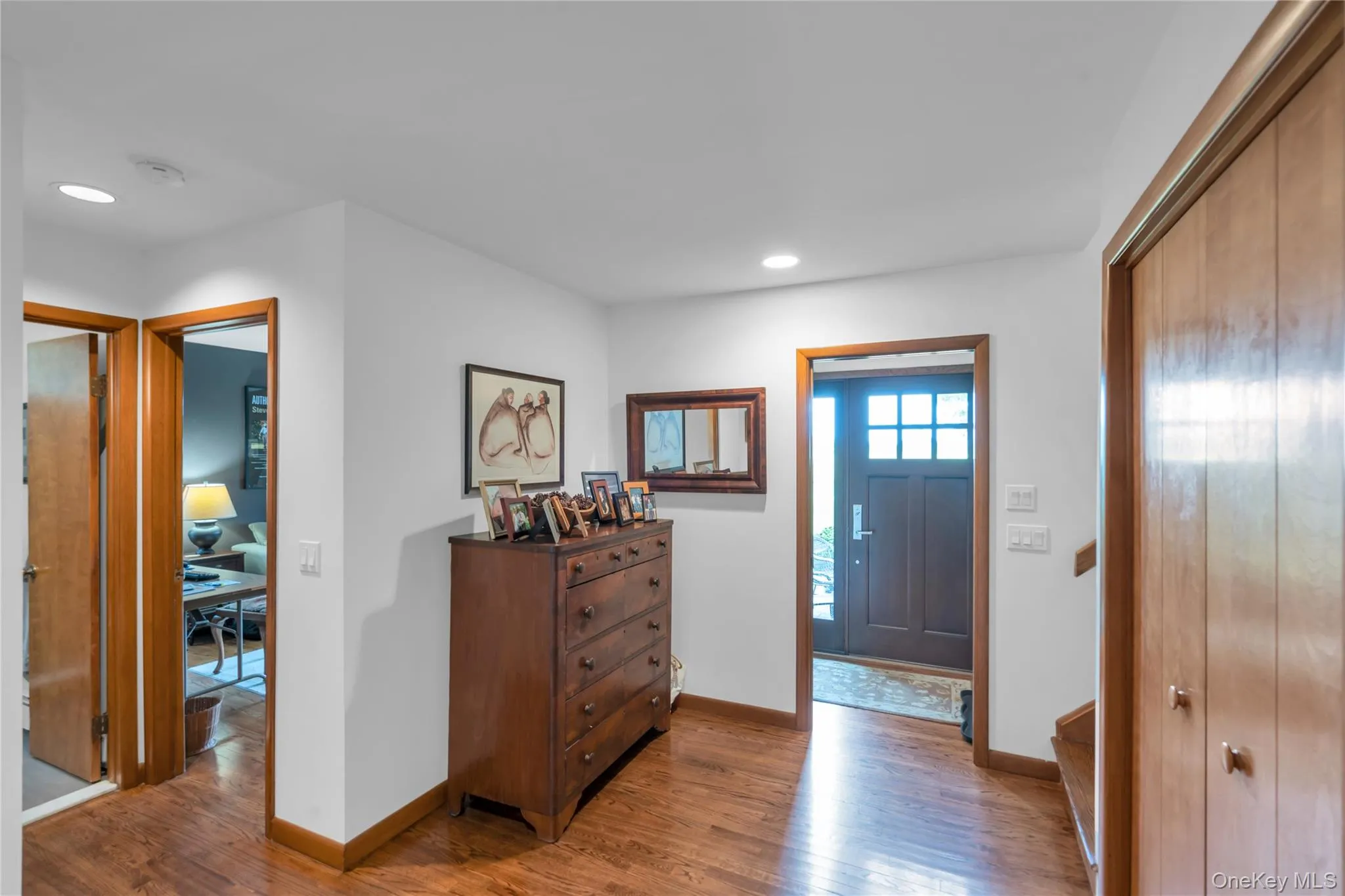 Dark wood-finish entry door with multi-pane window and coat hooks Dark wood-finish entry door with multi-pane window and coat hooks