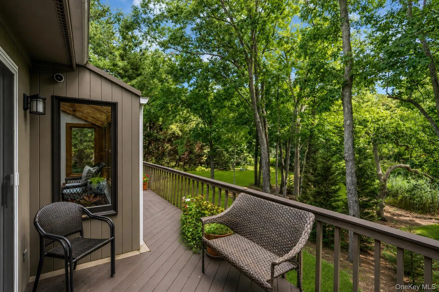 Deck featuring a wood railing and seating offering creek views Deck featuring a wood railing and seating offering creek views