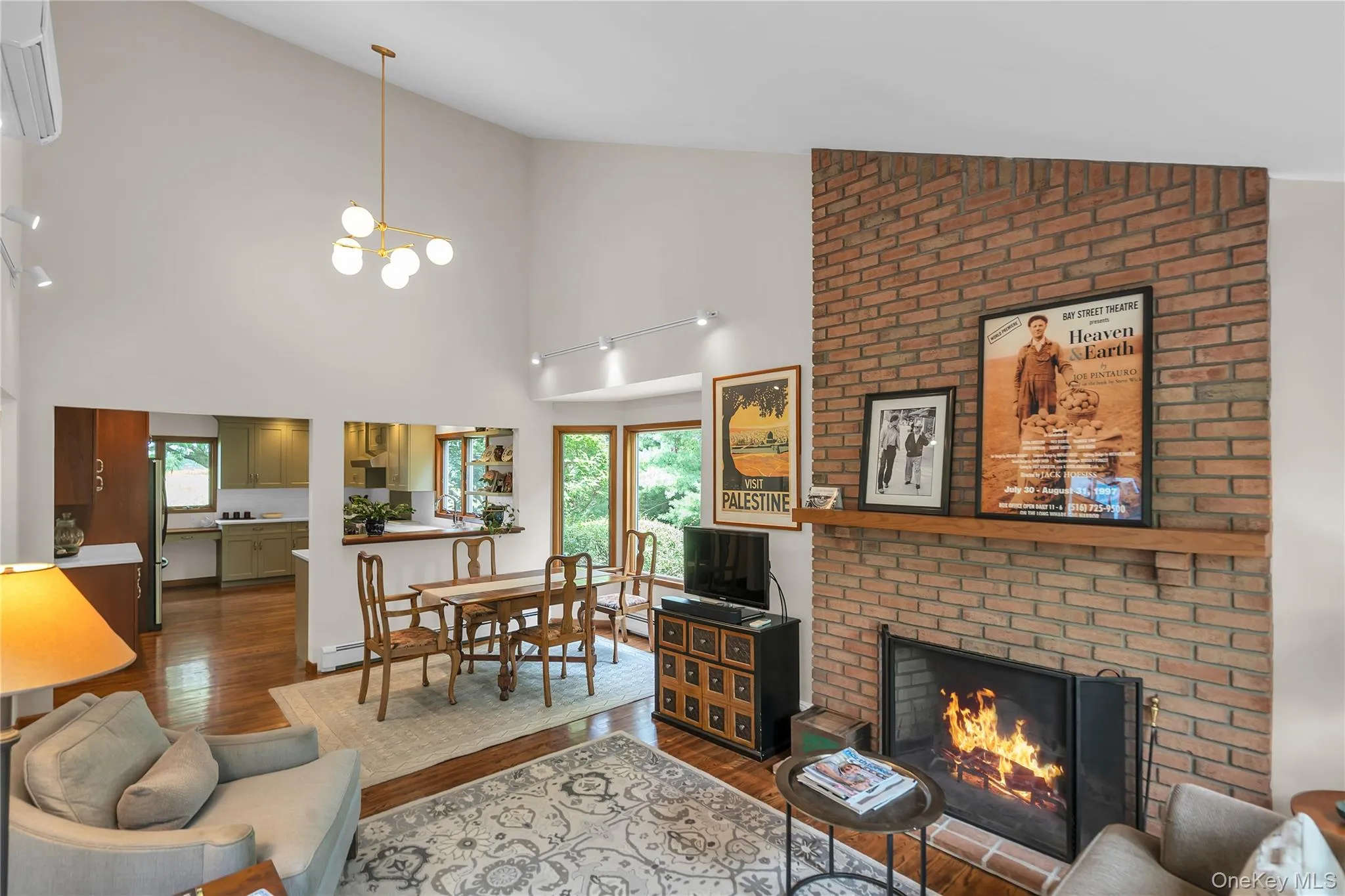 Vaulted ceiling with a modern spherical chandelier and real wood burning brick fireplace Vaulted ceiling with a modern spherical chandelier and real wood burning brick fireplace