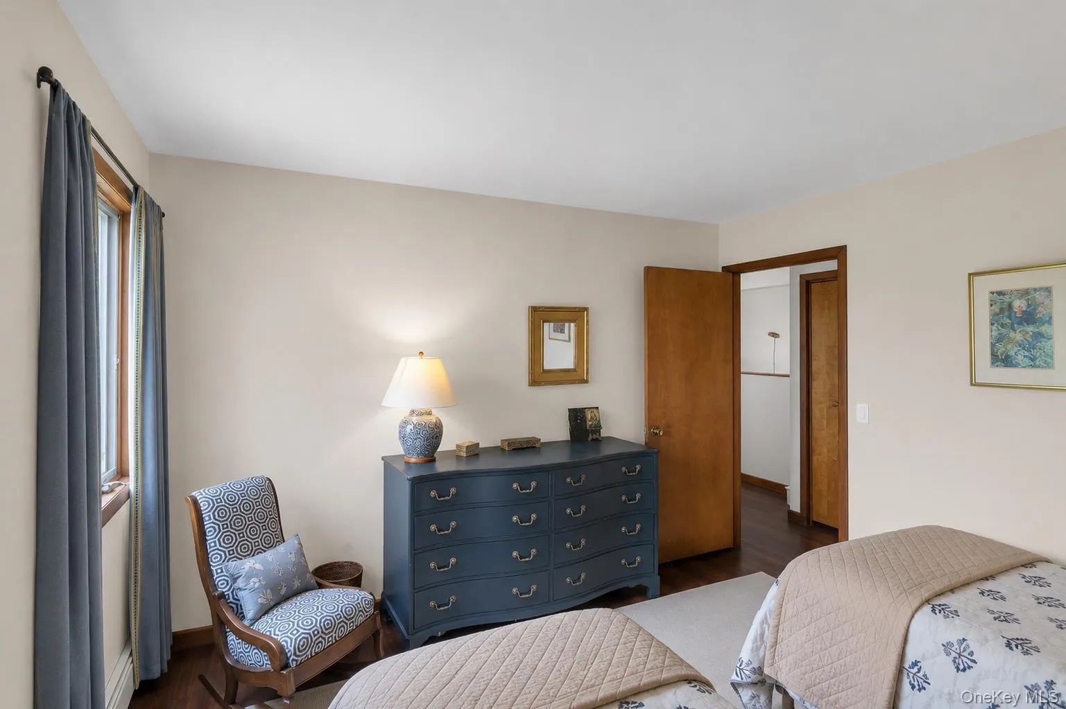 Bedroom 3. Hardwood-finish flooring, light-toned wall paint, and a wood-trimmed window Bedroom 3. Hardwood-finish flooring, light-toned wall paint, and a wood-trimmed window