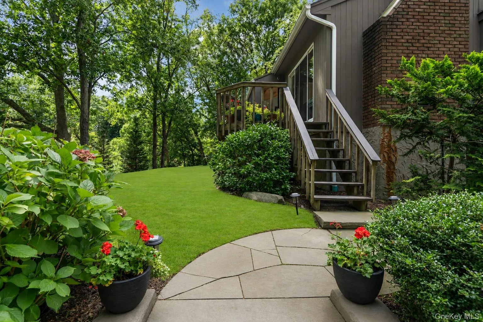 Custom stone walkway to the back deck and driveway Custom stone walkway to the back deck and driveway