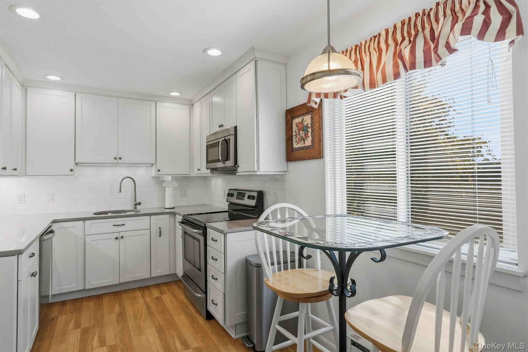 Sleek white cabinetry and quartz countertops create a fresh, modern setting Sleek white cabinetry and quartz countertops create a fresh, modern setting