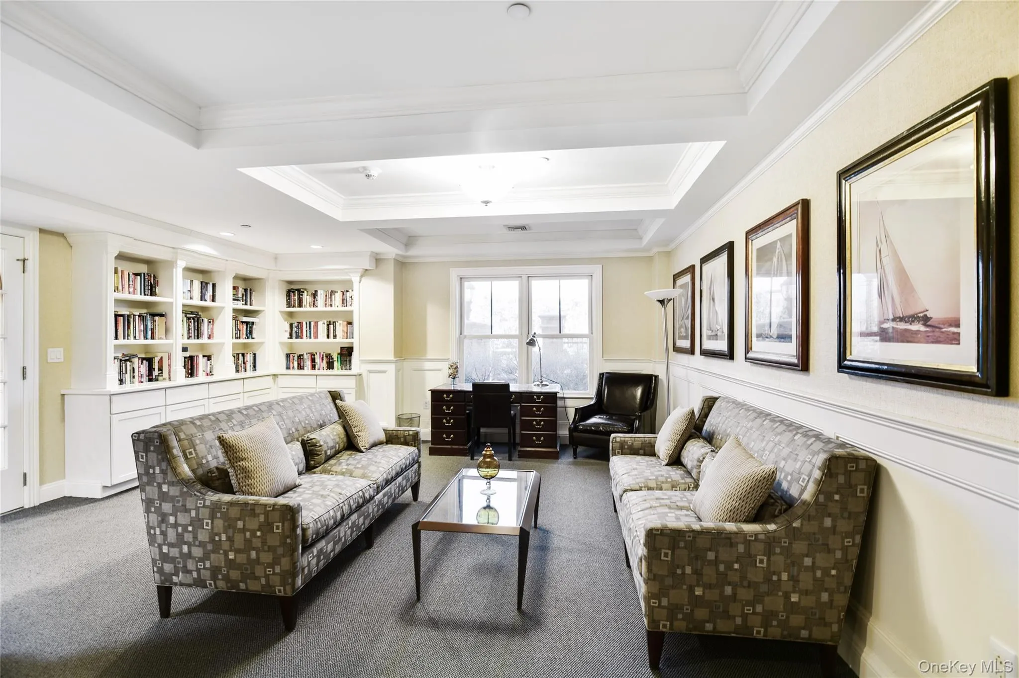 An elegant residents’ library just off the concierge lobby, featuring complimentary Wi-Fi and a kitchenette—perfect for hosting book clubs, gathering with neighbors, or welcoming guests while they wait. An elegant residents’ library just off the concierge lobby, featuring complimentary Wi-Fi and a kitchenette—perfect for hosting book clubs, gathering with neighbors, or welcoming guests while they wait.