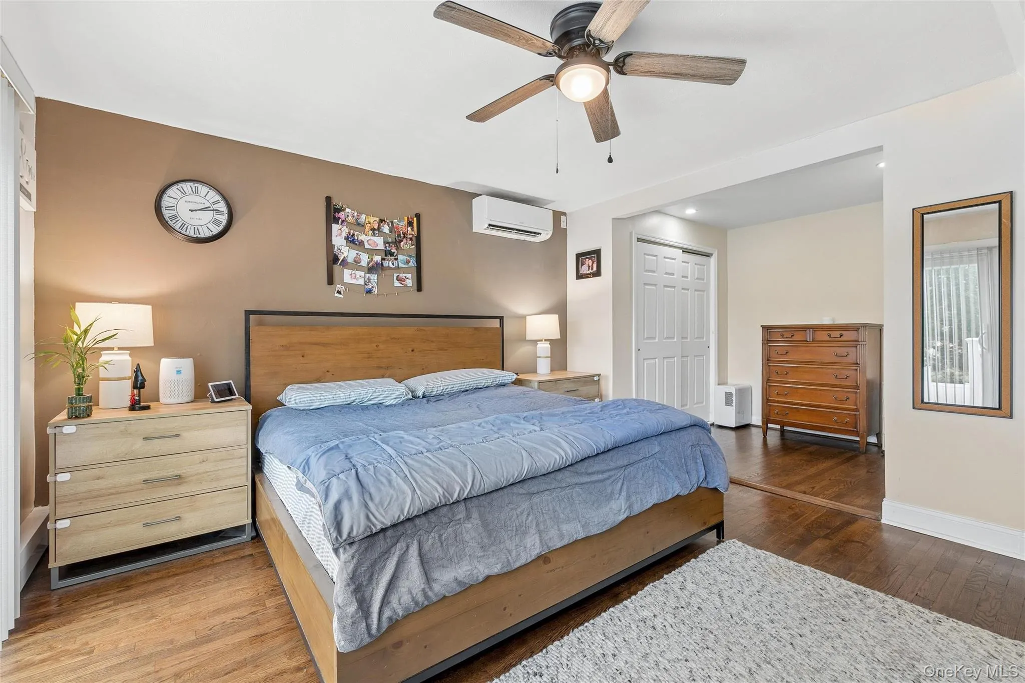 Hardwood flooring throughout, ceiling fan with integrated lighting, wall-mounted air conditioning unit, and recessed lighting Hardwood flooring throughout, ceiling fan with integrated lighting, wall-mounted air conditioning unit, and recessed lighting