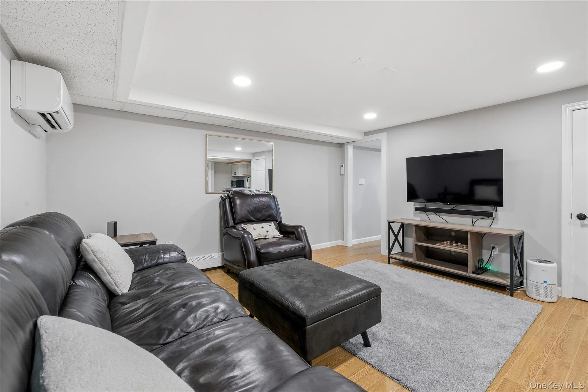 Recessed lighting, wood-finish flooring, and light gray wall tones Recessed lighting, wood-finish flooring, and light gray wall tones