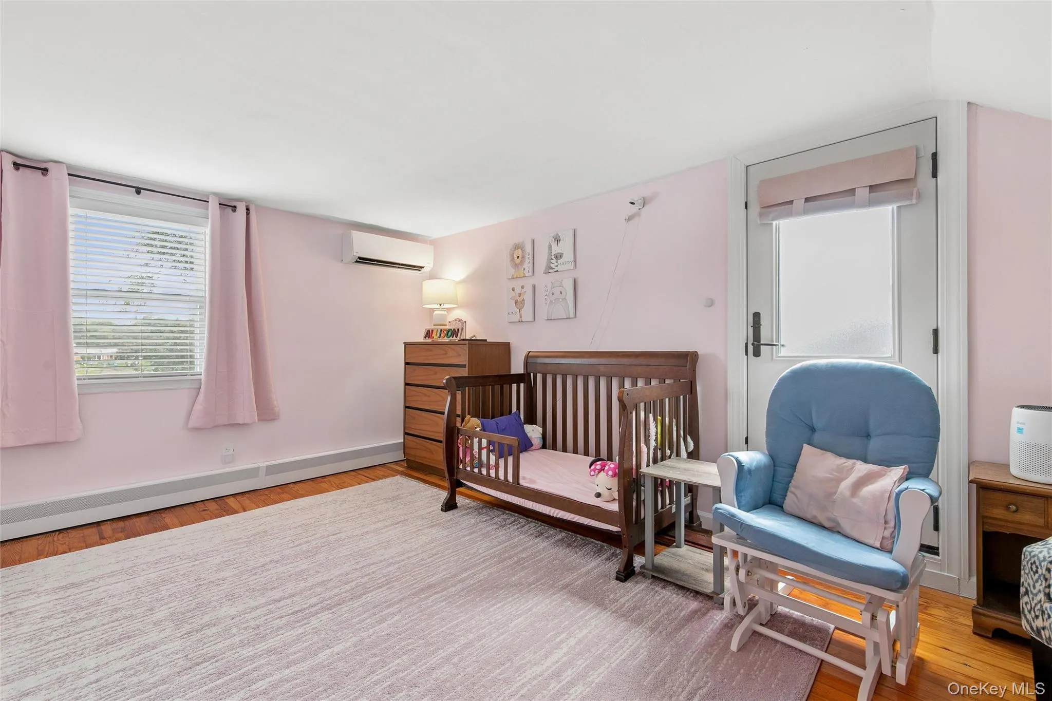 Wood-finish flooring with a neutral area rug Wood-finish flooring with a neutral area rug