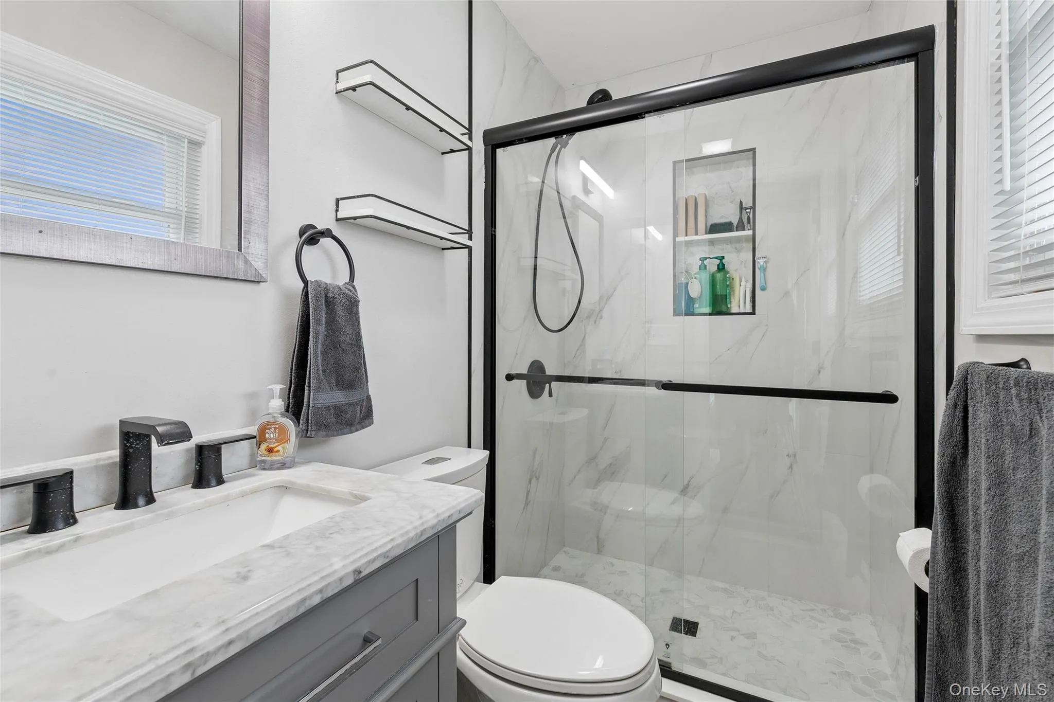 Glass-enclosed shower with a recessed niche and tile surround Glass-enclosed shower with a recessed niche and tile surround