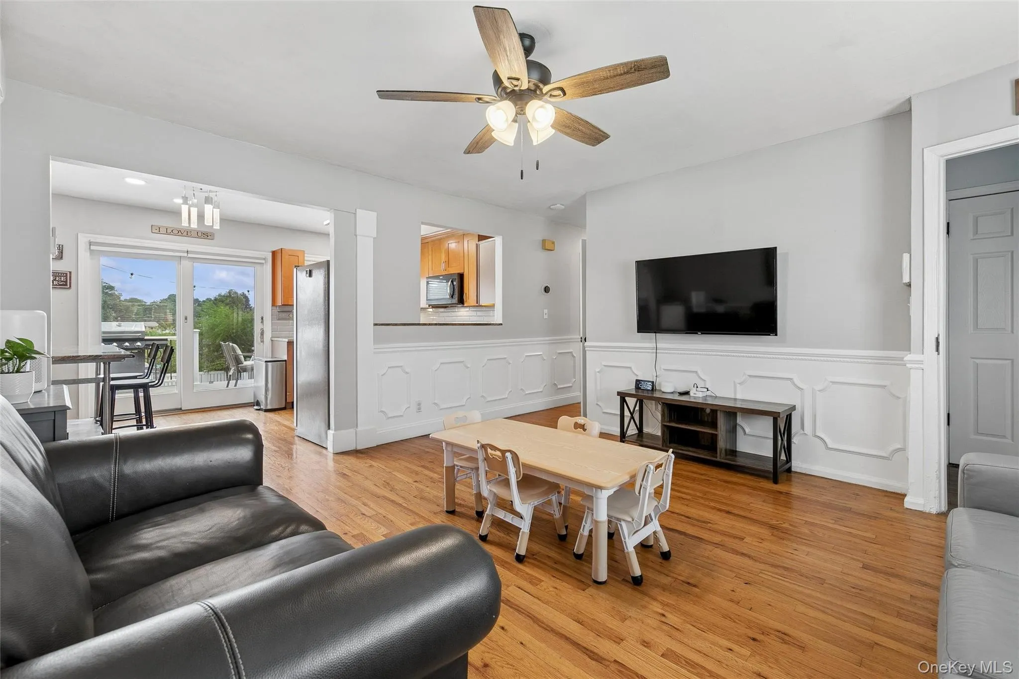 Hardwood flooring throughout, with a ceiling fan and light fixture Hardwood flooring throughout, with a ceiling fan and light fixture