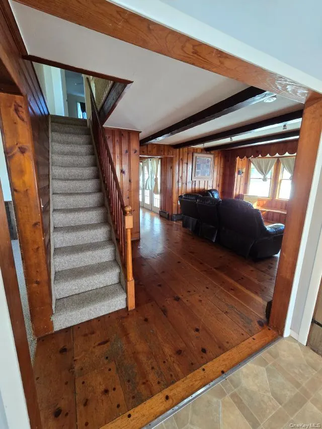 The Living Room Offers Original Beamed Ceilings, Wide Plank Hardwood Floors, Tongue & Groove Pine Walls, Ample Room For Furniture & A Charming Vintage Stairway To The Second Level. The Living Room Offers Original Beamed Ceilings, Wide Plank Hardwood Floors, Tongue & Groove Pine Walls, Ample Room For Furniture & A Charming Vintage Stairway To The Second Level.