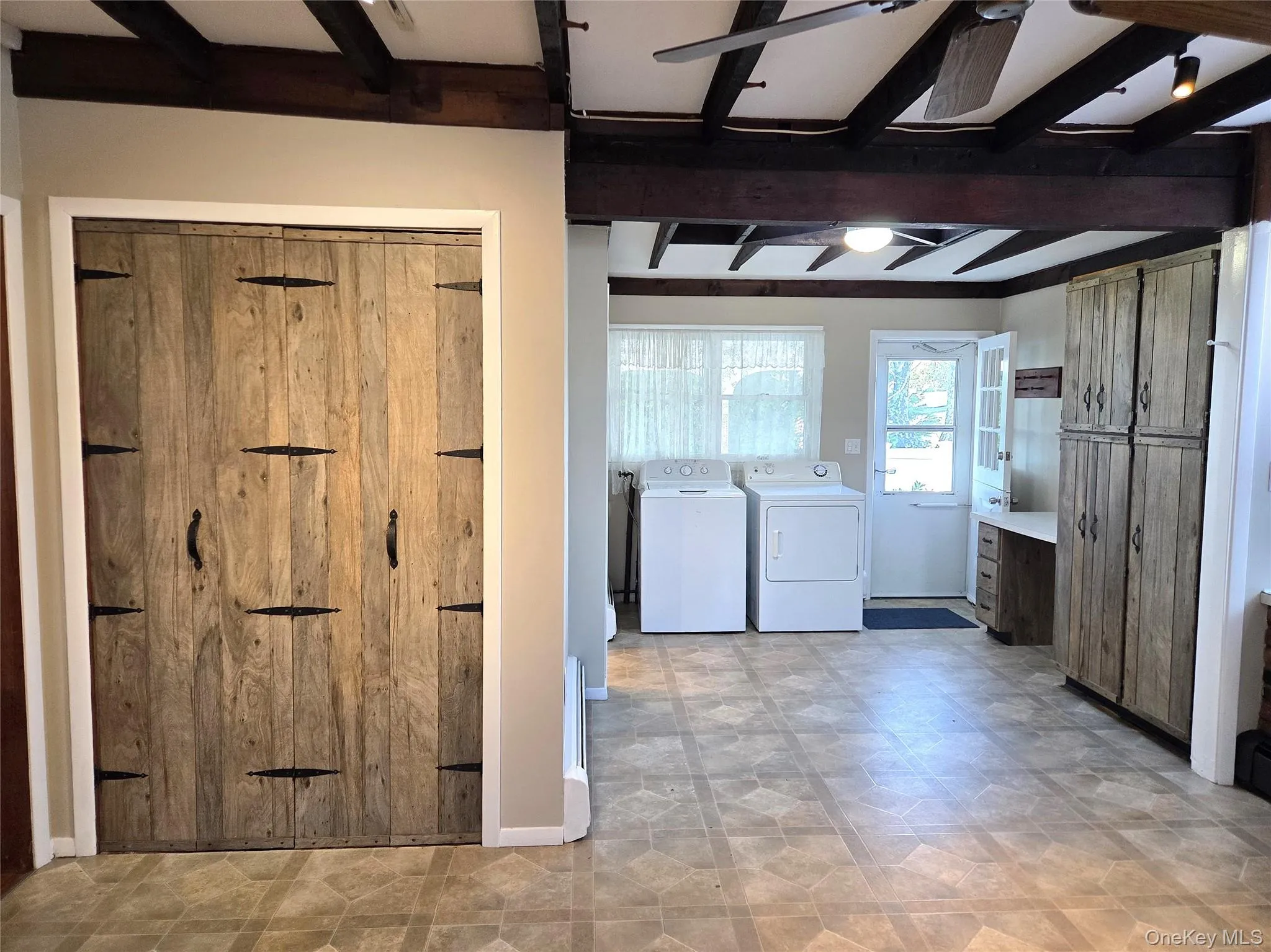 Large Eat In Kitchen With Original Beamed Ceilings, Walls Of Storage Cabinetry, A Separate Double Door Pantry, Ample Counter/Serving Space & Built In Barstool Area, Charming Brick Walls With A Built In Wall Oven & Separate Cooktop, Ample Room For A Good Sized Table & Chairs, And A Separate Mud Room With A Newer Full Sized Washer & Dryer, And Additional Storage/Cabinetry. Large Eat In Kitchen With Original Beamed Ceilings, Walls Of Storage Cabinetry, A Separate Double Door Pantry, Ample Counter/Serving Space & Built In Barstool Area, Charming Brick Walls With A Built In Wall Oven & Separate Cooktop, Ample Room For A Good Sized Table & Chairs, And A Separate Mud Room With A Newer Full Sized Washer & Dryer, And Additional Storage/Cabinetry.