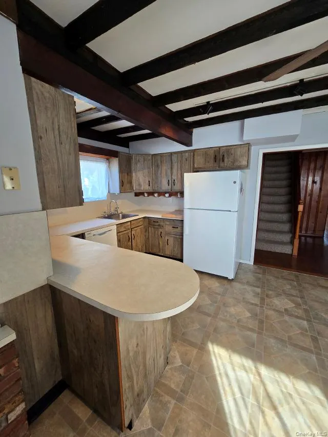 Large Eat In Kitchen With Original Beamed Ceilings, Walls Of Storage Cabinetry, A Separate Double Door Pantry, Ample Counter/Serving Space & Built In Barstool Area, Charming Brick Walls With A Built In Wall Oven & Separate Cooktop, Ample Room For A Good Sized Table & Chairs, And A Separate Mud Room With A Newer Full Sized Washer & Dryer, And Additional Storage/Cabinetry. Large Eat In Kitchen With Original Beamed Ceilings, Walls Of Storage Cabinetry, A Separate Double Door Pantry, Ample Counter/Serving Space & Built In Barstool Area, Charming Brick Walls With A Built In Wall Oven & Separate Cooktop, Ample Room For A Good Sized Table & Chairs, And A Separate Mud Room With A Newer Full Sized Washer & Dryer, And Additional Storage/Cabinetry.
