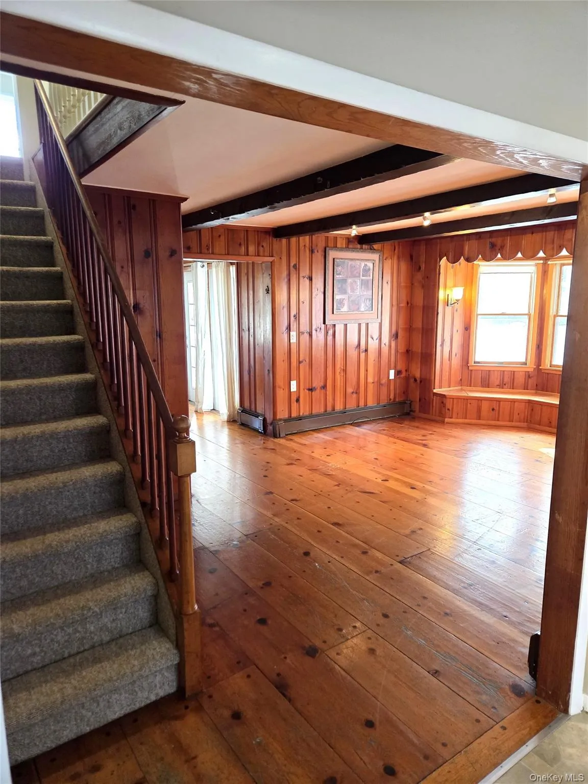 The Living Room Offers Original Beamed Ceilings, Wide Plank Hardwood Floors, Tongue & Groove Pine Walls, Ample Room For Furniture & A Charming Vintage Stairway To The Second Level. The Living Room Offers Original Beamed Ceilings, Wide Plank Hardwood Floors, Tongue & Groove Pine Walls, Ample Room For Furniture & A Charming Vintage Stairway To The Second Level.