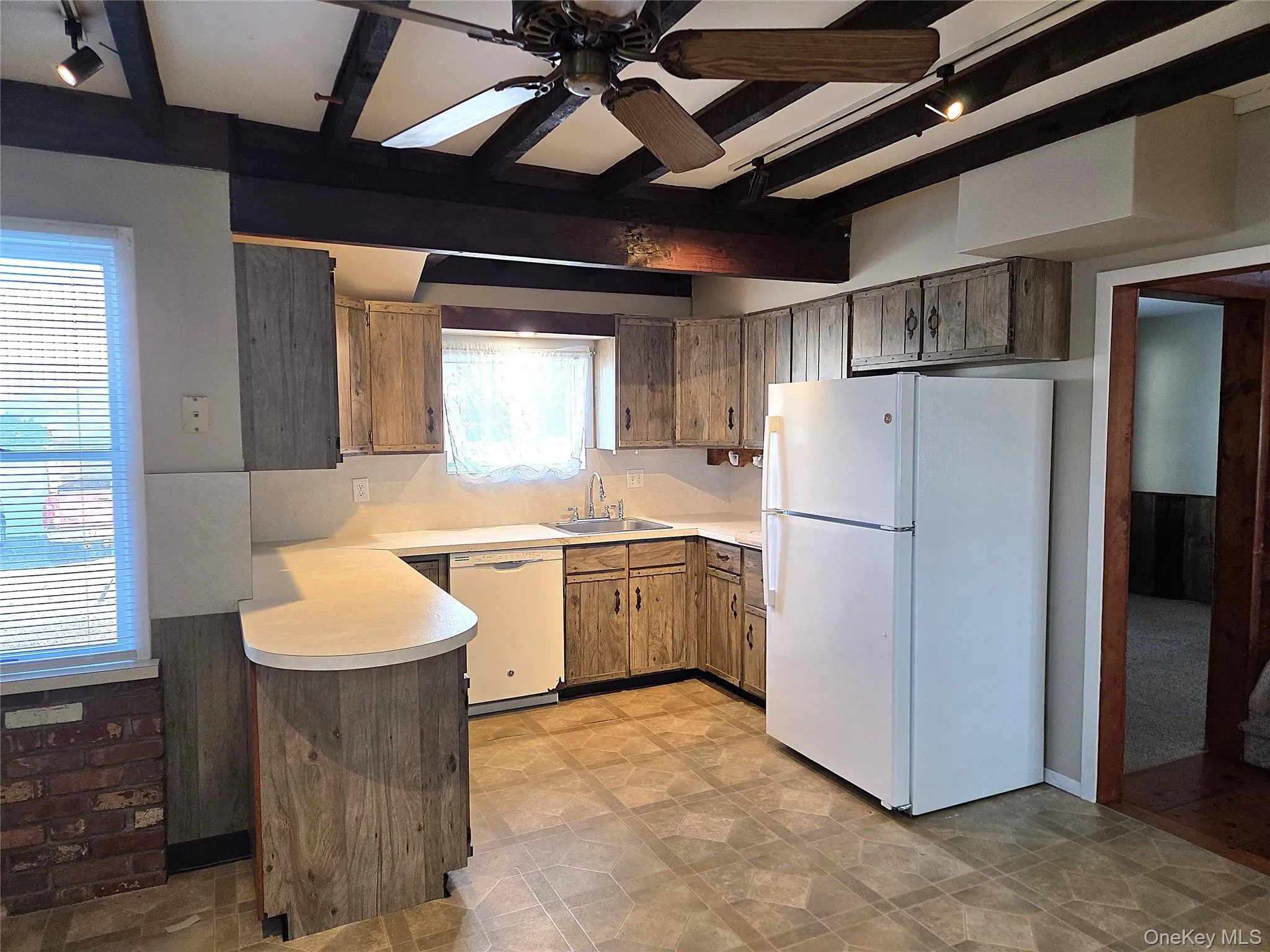 Large Eat In Kitchen With Original Beamed Ceilings, Walls Of Storage Cabinetry, A Separate Double Door Pantry, Ample Counter/Serving Space & Built In Barstool Area, Charming Brick Walls With A Built In Wall Oven & Separate Cooktop, Ample Room For A Good Sized Table & Chairs, And A Separate Mud Room With A Newer Full Sized Washer & Dryer, And Additional Storage/Cabinetry. Large Eat In Kitchen With Original Beamed Ceilings, Walls Of Storage Cabinetry, A Separate Double Door Pantry, Ample Counter/Serving Space & Built In Barstool Area, Charming Brick Walls With A Built In Wall Oven & Separate Cooktop, Ample Room For A Good Sized Table & Chairs, And A Separate Mud Room With A Newer Full Sized Washer & Dryer, And Additional Storage/Cabinetry.